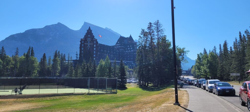 Fairmont Banff Springs Hotel with mountains behind in the summer