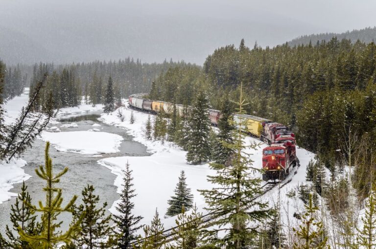 Freight train passing through snowy Morants Curve, Banff 