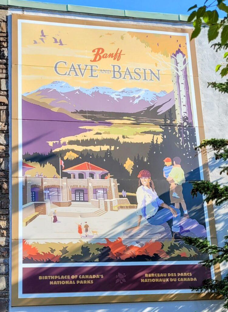 Poster on side of building advertising the Cave & Basin