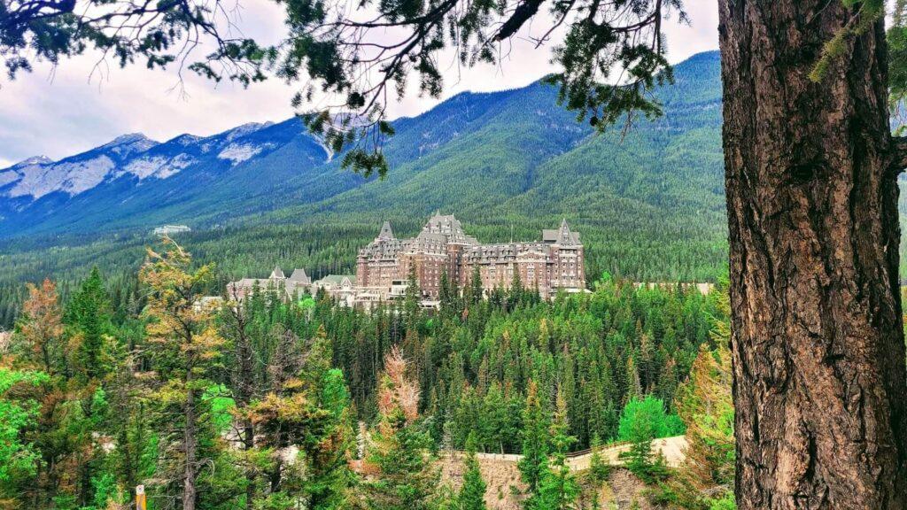 View of Fairmont Banff Springs hotel and surrounding mountains from Surprise Corner in Banff