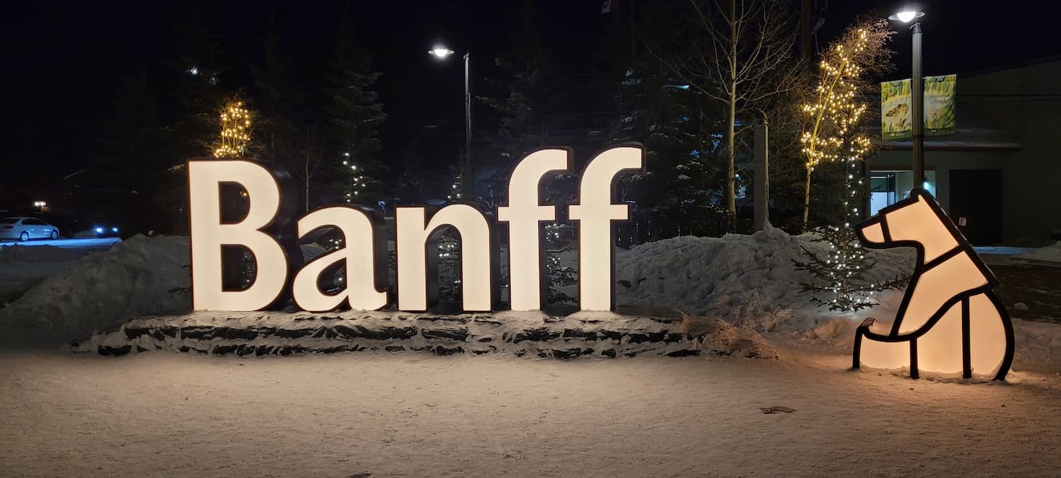 Banff town illuminated sign with xmas decorations at night