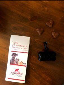 Heart shaped pet treats, poop bag holder and information leaflet about pets staying at the Canmore Inn and Suites in Canmore
