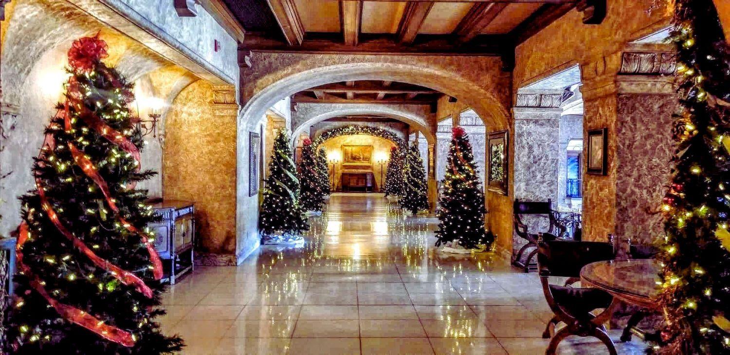 Christmas decorations and trees in hallway of Fairmont Banff Springs Hotel