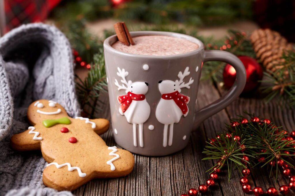 Cup of hot chocolate with cinnamon stick and ginger bread man